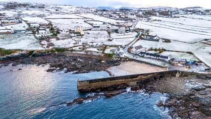 Aerial view of a snow covered Portnoo harbour in County Donegal, Ireland.