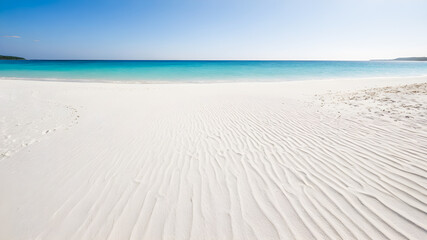 Fototapeta na wymiar Beautiful white sand beach with turquoise water and blue sky