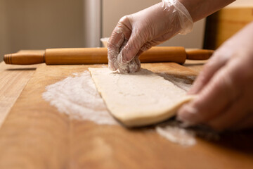 Preparation and rolling out puff pastry. Preparation of puff pastry dishes.
