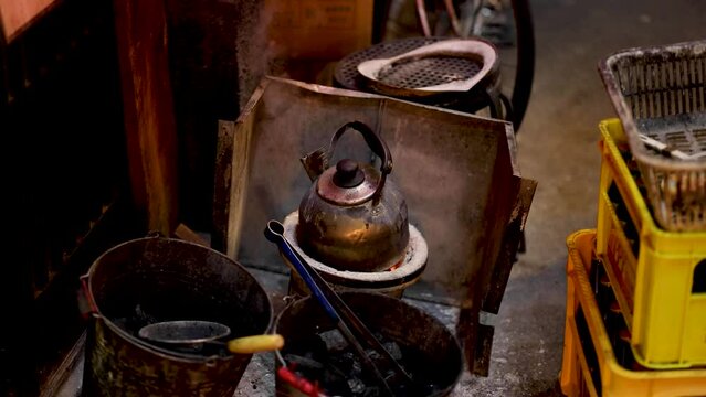 Traditional Kettle Boiling Over Charcoal