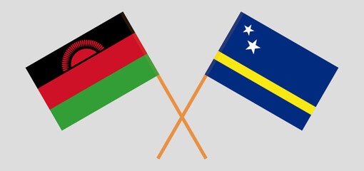 Crossed flags of Malawi and Country of Curacao. Official colors. Correct proportion