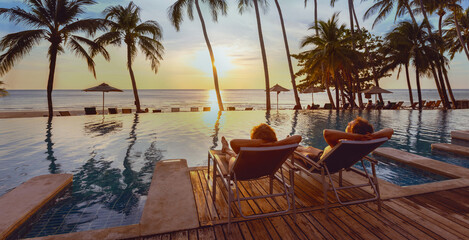 honeymoon couple relaxing near beach swimming pool in luxurious hotel, banner background, vacation travel - 757058593