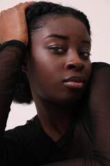 Vertical Indoor portrait of confident African American woman looks at camera.