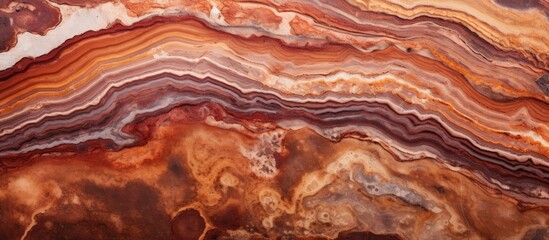 A close up of a brown rock with a marble texture, resembling amber wood. The geological phenomenon showcases a peachcolored pattern, making it a piece of art in nature