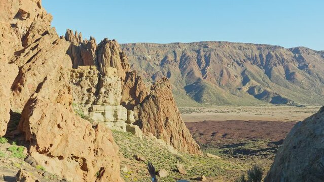 Woman on a vacation in Teide national park, holding baby in ergo carrier