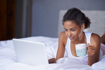 Black woman, computer or tea in bed to relax, scroll or search on internet, social media or...
