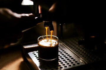 Fototapeta na wymiar coffee maker pouring espresso