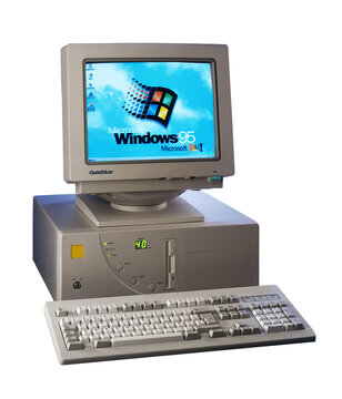 Nineties obsolete tower pc computer and Windows 95 logo on scree