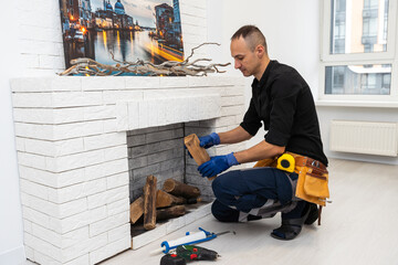 Fototapeta premium Fireplace installing in white brick wall.