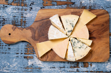 Tasting plate with small pieces of different French cheeses, variety of cheeses