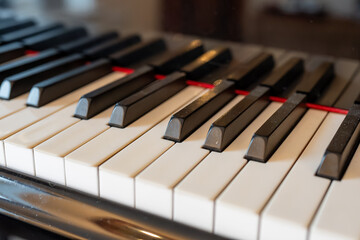 Old grand piano with ivory keys close up