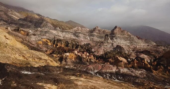 Wonderful salt mountain colorful rock geology natural landscape martial view rainbow hills amazing panoramic grey gold color drone shot in middle east Asia Iran highlands fog clouds on peak in hiking 
