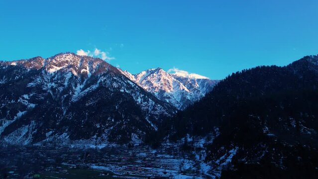 Snow-capped Himalayan mountains during sunset with clear skies in winter in Kashmir