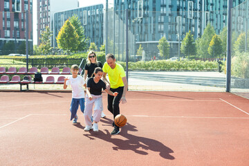 Caucasian family playing basketball together. Happy family spending free time together.