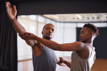 Art, creative or dance with student and teacher in class together for theater performance training. Fitness, learning and school with black man instructor teaching dancer in studio for production