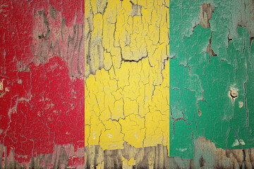 Guinea flag painted on the cracked wall