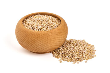 Barley groats in a small wooden bowl, isolated on white background.