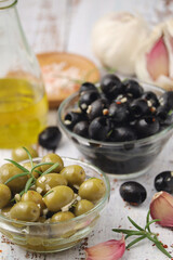 Black and green olives in glass bowls