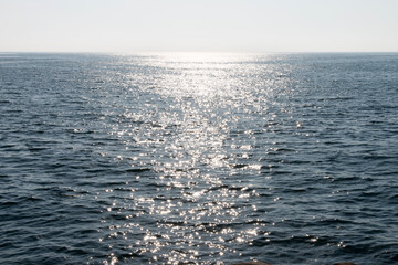 The sea with sunlight reflection and horizon
