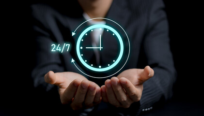 nonstop service concept. businessman hand holding virtual 24-7 with clock on hand for worldwide...