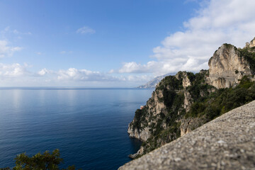 Fototapeta na wymiar Amalfi coast, view of the mountainous coast washed by the sea and caressed by the blue sky