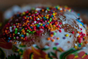 Fototapeta na wymiar Traditional Christian Easter cake with icing and Easter eggs close up