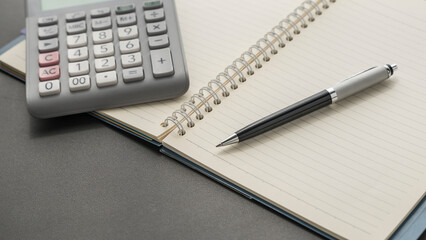 background image with pen and calculator on the notebook . 