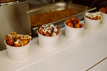 Delicious churros sticks with cream and chocolate in a street cafe.