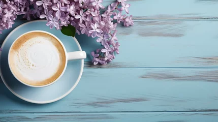 Tuinposter Cup of coffee with milk and bouquet of lilac on blue w © franklin