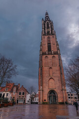 Medieval church tower Onze Lieve Vrouwetoren on a rainy day in Amersfoort, Netherlands. Gothic monument in town and the third highest church tower in Holland