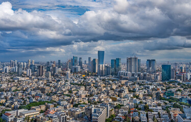 Tel Aviv old buildings and skyline of modern skyscrapers of Sarona and Ayalon districts.