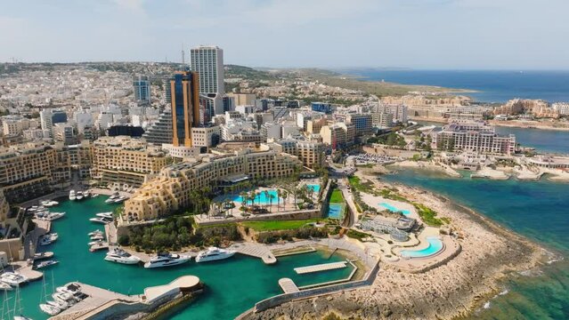 Aerial drone day view of highest and modern towers of Malta island. St. Julians city