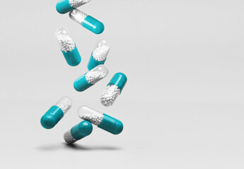 Falling blue and white capsules on a white background. - 757126591
