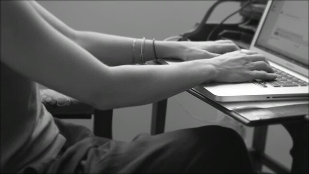 Black And White Video Of A Woman Typing On Keyboard