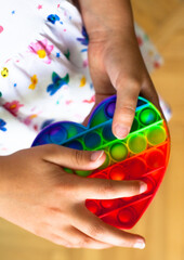 Girl holding heart shaped pop it toy