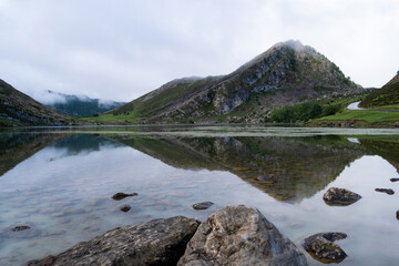 Fototapeta premium Beautiful view of Lake Enol with fog and rain. The Lakes of Covadonga. Asturias - Spain