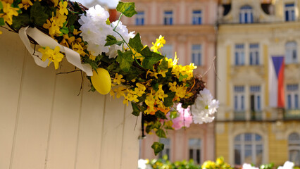 Beautiful colorful decor for Easter. Traditional Easter painted eggs and ribbons on a birch tree in Easter decor at the spring fair in Prague, Czech Republic. Selective focus.