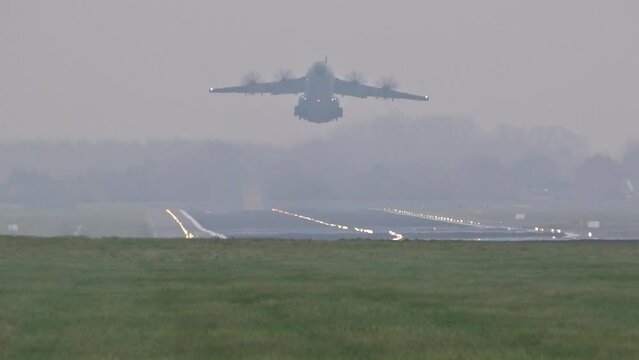 heavy military transport airplane toke off taking off departure departing runway generic airport bad weather cloudy foggy