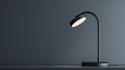 A black lamp emits a soft white light, creating a striking contrast in the dark