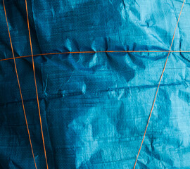 Blue crumpled synthetic fabric.