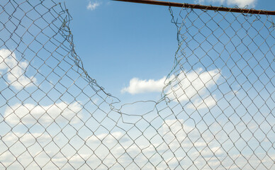 Broken metal mesh fence