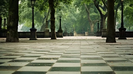  Stone walkway in the park with green trees in the background. © ismodin