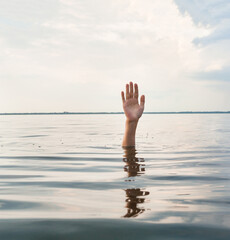 Hand sticking out of water.