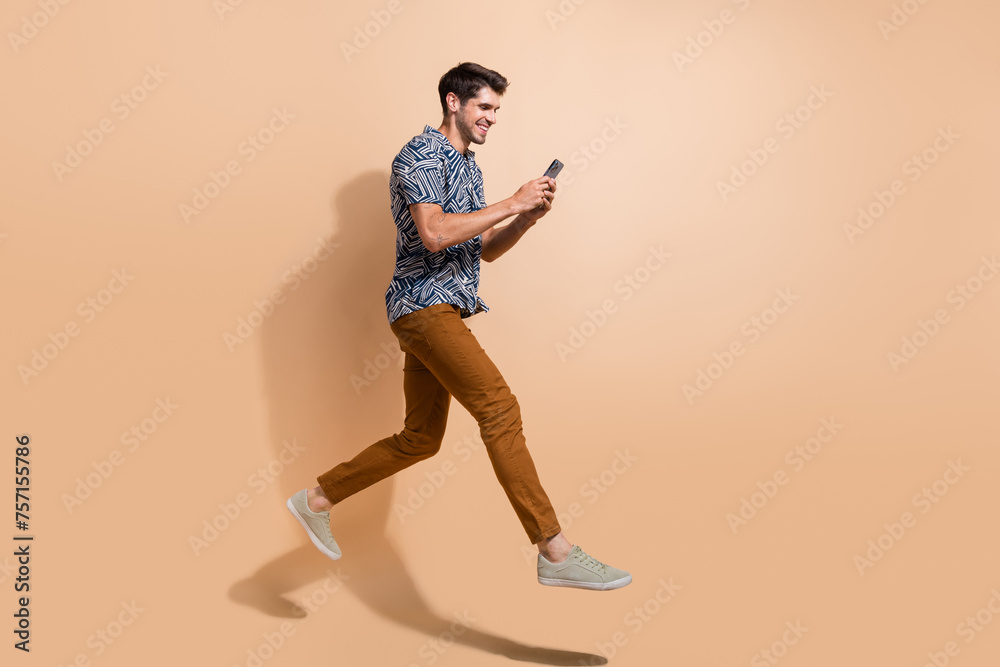 Sticker Full body length photo of professional content maker running with apple iphone 15 going post more videos isolated on beige color background