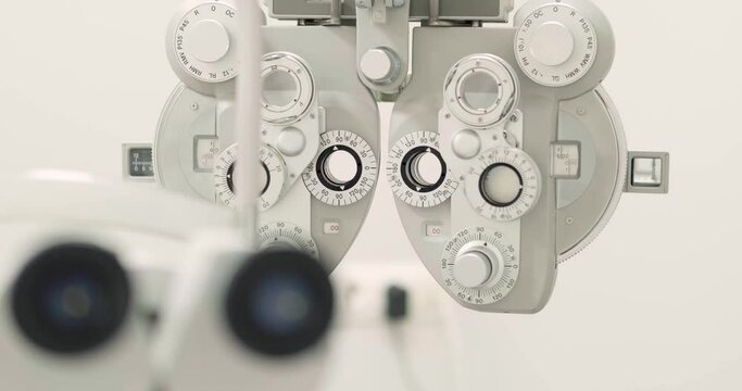 close up of phoropter, specialized instrument used in eye examinations to measure refractive errors and determine eyeglass prescriptions, eye medical clinic