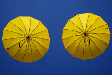 yellow umbrella against blue sky