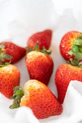 Fresh and Moldy Strawberries in a Glass Bowl on a White Napkin