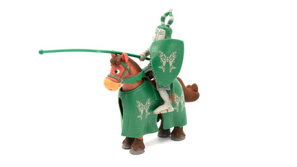 Figurine of a medieval toy knight on horse isolated on white