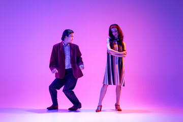 Artistic, talented, positive young man and woman, stylish couple dancing retro dance, boogie woogie...