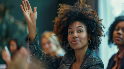 Portrait of a black afro american business woman rising hand to ask a question during a meeting , the powerful businesswoman is not afraid to take speak in public in front of her coworkers - Powered by Adobe